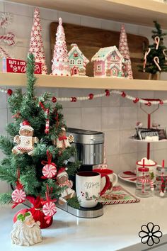 a christmas tree with candy canes and gingerbread houses on the shelves behind it