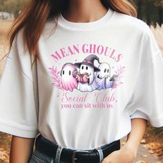 Mean Ghouls Social Club Shirt, Ghost Shirt, Halloween Shirt, Pink Ghost T-shirt, Girls Club Shirt, Let's Go Ghouls, We Wear Pink Shirt -------------------------------------------------------------------------------------------------- 🌟 🌟 🌟 🌟 🌟 🌟 🌟 🌸 Material: - Made of 50% cotton and 50% polyester. - Medium-heavy fabric. - True to size. - Unisex design fits like a traditional semi-fitted men's t-shirt but looks great on both men and women. Men should order their usual size or size up for a looser fit. - For detailed sizing and color options, please refer to the listing images. - Actual colors may vary due to differences in monitor and screen displays. Please note that colors may slightly differ from screen to printed product. - A funny shirt ideal for fathers, brothers, dads, boys, Halloween Anime Print Crew Neck T-shirt, Halloween Anime Print Cotton T-shirt, White Tops With Anime Print For Halloween, Cotton Anime Print T-shirt For Halloween, Casual Anime Print Top For Halloween, White Anime Print Top For Halloween, Halloween Cotton Top With Anime Print, Cute Halloween T-shirt For Streetwear, Mean Ghouls