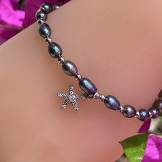 Use "Buy2" Promo Code for Special Price! Freshwater Black Pearl Adjustable Bracelet with Cubic Zirconia Charms. Adjusts from 5" to 8.5". Great for all ages and fits just about anyone. Choose from two styles. Gold or Silver accents with black pearls and starfish or plumeria cubic zirconia charms. Mix and match. Buy to for a special price! Freshwater Black Pearls Adjustable Bracelet Adjusts from 5" to 8.5" Gold or Silver accents Starfish or Plumeria Charm Adjustable Nickel-free Pearl Bracelet For Gift, Adjustable Silver Pearl Bracelet For Friendship, Adjustable Silver Pearl Bracelet Gift, Adjustable Bracelet With Lobster Clasp For Birthday Gift, Pearl Bracelet Stack, Black Pearl Bracelet, Pearl Bracelet Gold, White Pearl Bracelet, Black Pearls