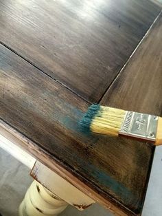 a paintbrush sitting on top of a wooden table