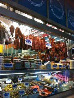 a display case in a store filled with lots of meats and other food items