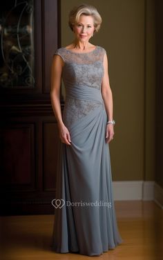 an older woman in a gray dress posing for the camera with her hands on her hips