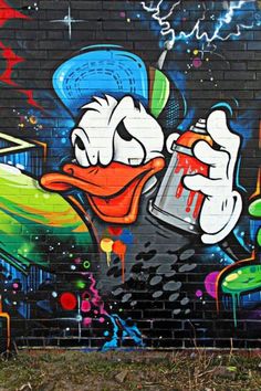 graffiti painted on the side of a building with a duck holding a beer in it's mouth