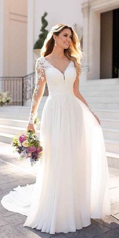 a woman in a white wedding dress is walking down the street with her hand on her hip