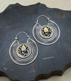 HANDMADE Beautiful mandala Om earrings in dual silver and gold tone. With a beautiful design, these are sure to get some attention! Handmade with high quality hypoallergenic Jewelery brass, nickel free. SIZE Aprox Drop Length: 5.3 cm Aprox width: 4.2 cm LINK Please follow the link to view my shop for other beautiful pieces. https://www.etsy.com/uk/shop/JagathaStudio Bohemian Silver Dual-tone Earrings, Bohemian Dual-tone Silver Earrings, Handmade Hoop Earrings For Diwali Gift, Bohemian Dual-tone Earrings For Festivals, Handmade Temple Jewelry Hoop Earrings For Festivals, Silver Brass Hoop Earrings For Festive Occasions, Chandbali Hoop Earrings With Oxidized Finish For Gift, Silver Spiritual Hoop Earrings, Bohemian Dual-tone Earrings As Gift