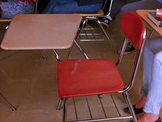 three children's desks and chairs in a classroom