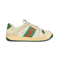 Gucci 'Screener' low-top sneakers in off-white and green leather with a beige and green rubber sole. Features colour distressing throughout shoe, green and red racing canvas racing stripes on the sides, gold and silver enamel filled logo on the toe, wide flat cream laces, gold foil logo on the heels, logo tab on the tongue, and white terry-cloth lined interior. Includes dust bag and box (some damage to box). Brand = Gucci Condition = 9/10, Brand new in box, tried on condition, some glue marks on Gucci Screener, Beige And Green, Gold Foil Logo, Racing Stripes, Handbag Wallet, Green And Red, Cream Lace, Wallet Accessories, Silver Enamel