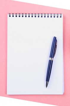 a notepad with a pen on top of it