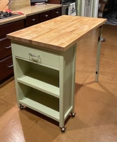 a kitchen island with a butcher block top