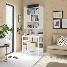 a living room filled with furniture and bookshelves