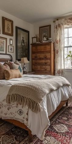 a bedroom with a large bed and lots of pictures hanging on the wall above it