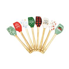 six wooden spatulas with christmas designs on them