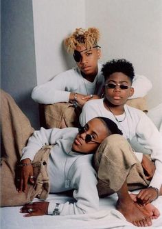 two women sitting next to each other wearing sunglasses