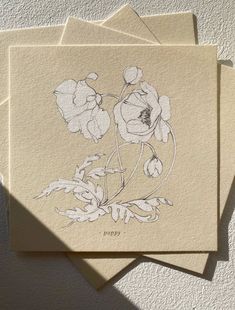 three cards with flowers on them sitting next to each other