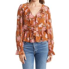 Spring Florals Are Here! The Deets: Ruffle Vneck Floral Blouse | Size Xs | Color: Burnt Orange + Gorgeous Pink/White Floral Print Throughout | Perfectly Paired For The Office W. A Pencil Skirt Or Pants Or Casual Cute For Date Night Or Brunch W. Your Fav Denim | Features: Ruffle V Neck + Sheer Balloon Sleeves + Elastic Drawstring Waist + Lined Throughout Minus The Sleeves + Fits Up To A Small + Machine Washable On Delicate | 17” Bust + 22” Length | 100% Polyester | Contact For Questions | No Trad Fall V-neck Top With Ruffle Hem, Feminine V-neck Top With Ruffle Hem, Fall V-neck Ruffled Tops, Spring V-neck Blouse With Ruffle Hem, Spring V-neck Top With Ruffle Hem, Chic V-neck Floral Print Top, Pink V-neck Blouse With Ruffles, Feminine V-neck Blouse For Brunch, Feminine V-neck Tops For Brunch