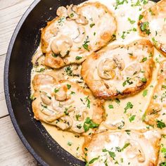 a skillet filled with food on top of a wooden table