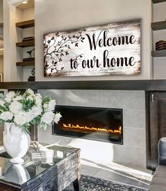 a living room filled with furniture and a fire place in front of a sign that says welcome to our home