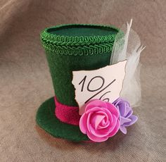 The Mad Hatter's hat. Perfect for teatime and parties. The item pictured may be slightly different from what you see.  This top hat is roughly 3.5 inches tall. Has 2 alligator clips on the bottom. Handmade with custom templates. You are always welcome to commission a custom order. Feel free to send us a message for any questions. Novelty Mini Hats With Curved Brim For Gifts, Novelty Mini Hat With Curved Brim As Gift, Kentucky Derby Gift Top Hat With Short Brim, Kentucky Derby Short Brim Top Hat Gift, Novelty Short Brim Hat As A Gift, Novelty Short Brim Hat As Gift, Wonderland Mad Hatter, Mad Hatter Hat, Mini Top Hat