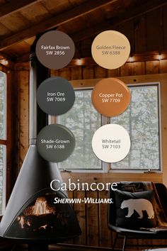 the interior of a cabin with wood burning stove and various color options for paint swatches