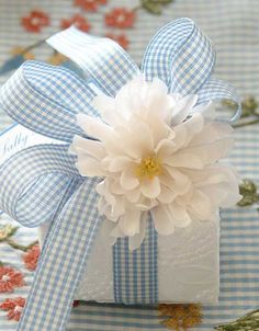 a blue and white gift box with a flower on top