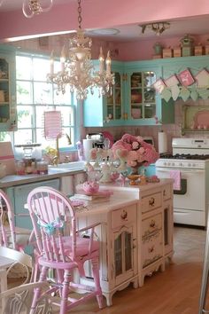 a kitchen filled with lots of pink and blue furniture