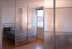 an empty bedroom with sliding glass doors on the wall