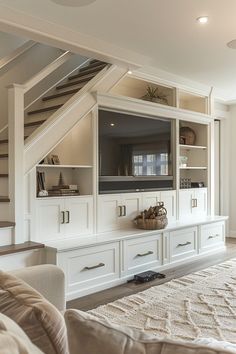 a living room filled with furniture and a flat screen tv mounted on top of a wall