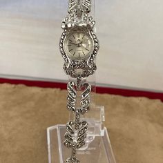 Vintage Stunning 1950's Bucherer Ladies Wrist Swiss Peak-A-Boo Watch from .800 Swiss Euro Silver and Marcasite Settings with Safety Chain This beautiful ladies wristwatch is in Excellent vintage condition. All the stones are intact, it winds and runs. It's extra nice 6.25 inches in length 3/4 inch diameter Silver Case Rare in this running condition shipping included The mineral marcasite, sometimes called white iron pyrite, is iron sulfide with orthorhombic crystal structure. It is physically an Timeless Collectible Jewelry With Round Dial, Vintage Jewelry And Watches With Diamond Hour Markers, Vintage Diamond Watch With Round Dial For Formal Occasions, Antique Diamond Watch For Evening, Vintage Diamond Watch For Formal Occasions, Silver Art Deco Watches For Weddings, Art Deco Silver Wedding Watches, Collectible Timeless Jewelry With Diamond Hour Markers, Vintage Silver Metal Jewelry And Watches