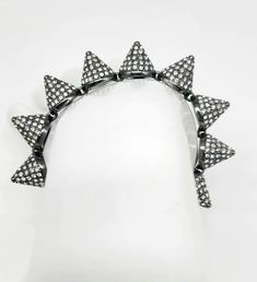 "Gunmetal Rhinestone Bracelet, Spike Bracelet, Spiked Bracelet, Triangle Bracelet, Punk Spike Bracelet, Brutalist Bracelet, Eddie Borgo Cone Measurements: 7\"L by .5\"W Metal: Gunmetal Filled Findings: Slide Clasp Finish: Polished Excellent Condition If you love gunmetal as much as I do you will know that it is quite difficult to find pieces made for women. If you are lucky enough to find one it most likely not a top-notch, high-quality designer piece. Well, be prepared to be shocked and amazed! Let me introduce you to Eddie Borgo, jewelry designer to the stars, who takes the beauty and luxury of fine jewelry and gives it some serious attitude! This GLAMOROUS piece is COMPLETELY ENCRUSTED IN SWAROVSKI CRYSTALS that have been pave set into gunmetal filled cone shaped spikes. Even the clasp Edgy Metal Jewelry With Spikes, Adjustable Edgy Jewelry With Spikes, Edgy Metal Bracelets With Spikes, Edgy Metal Spike Bracelets, Edgy Spiked Metal Bracelets, Edgy Metal Bracelets For Parties, Edgy Spiked Jewelry For Parties, Punk Style Spiked Bracelets As Gift, Edgy Adjustable Metal Chain Bracelet