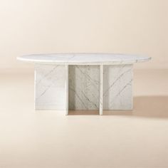 an oval marble table with two columns on each side