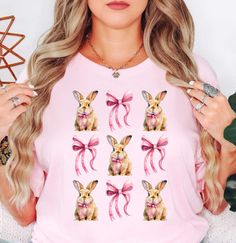 Coquette Bow and Bunnies (4) (Tee) T-Shirt | Easter Fashion | Unique Gifts for Family Friends  Hop on by and check out our Easter t-shirt collection, where festive charm meets comfort in every stitch! Embrace the spirit of the season with our range of delightfully designed tees, featuring whimsical Easter motifs and vibrant colors that capture the essence of springtime joy. Crafted from premium materials for maximum coziness, these t-shirts are perfect for egg hunts, family gatherings, or simply adding a touch of seasonal flair to your everyday ensemble. Browse our collection now and elevate your Easter wardrobe with style and charm today!   Key Features: High-Quality Material: Made from the softest washed, garment-dyed, and durable fabric, this T-shirt is built to last and keep you comfor Cute Crew Neck Easter Tops, Cute Easter Crew Neck T-shirt, Cute Easter T-shirt With Crew Neck, Cute Pink Tops With Bunny Print, Cute Pink Bunny Print Tops, Cute Pink Top With Bunny Print, Pink Cotton Easter T-shirt, Easter Graphic Print Short Sleeve Tops, Easter Pink Cotton T-shirt