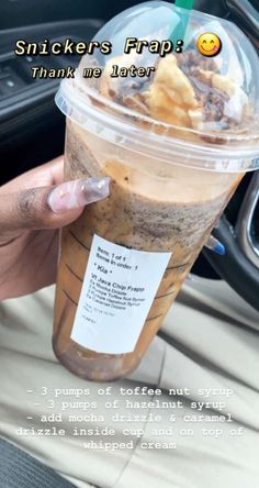 a person holding up a drink in their hand with the caption, snickkers frap thank us later