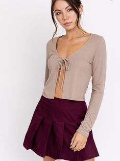 Look on trend with this front tie long sleeve top. A material so soft, It'll be your new go to shirt. Fits the wardrobe all year long, plus we love a good neutral, am I right? Casual Long Sleeve Top With Tie Sleeves, Long Sleeve Tops For Winter Date Night, Long Sleeve Tops For Date Night In Winter, Winter Long Sleeve Tops For Date Night, Trendy Tops With Tie Sleeves For Fall, Beige Tops For Fall Day Out, Trendy Tie Sleeves Blouse For Fall, Beige Top For Fall Day Out, Beige Top For Day Out In Fall