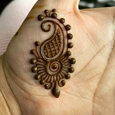 a hand with a henna tattoo on it