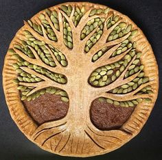 a wooden plate with a tree design on the front and sides, made to look like it has leaves growing out of it