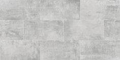 a white tile wall with grey grungy paint