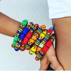 These thick traditional Zulu bangles are made with vibrantly colored beads. Not only are they beautiful but did you know that each color has a meaning? Here is what the colors mean: Pink - adds emphasis to a promise Black - marriage Blue - faithfulness Green- contentment Yellow-wealth Red- strong emotion White-love Please note that you will receive your bangle in the same color you've selected but no two items are exactly the same design.Expect each one to be equally beautiful, with its own vari Traditional Yellow Ceremonial Jewelry, Traditional Multicolor Ceremonial Bracelets, Zulu Beads Outfit, Zulu Traditional Beads, Traditional Beads African, Black Marriage, Zulu, Matching Necklaces, Arm Candy