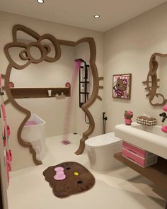 a bathroom decorated in pink and brown with hello kitty decals on the wall, toilet seat cover, rugs and shelves