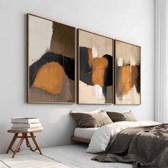 two paintings hanging on the wall above a bed