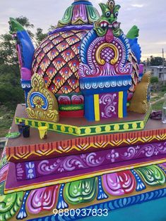 an elaborately decorated float in the shape of a peacock on top of another boat