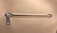 a close up of a purse with a metal handle on the front and side of it