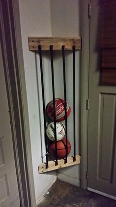 a basketball and soda can on a wooden shelf in the corner of a door way