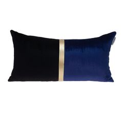 a black and blue pillow with gold stripeing on the side, sitting against a white background