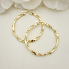 Stunning real 14k yellow gold polished 3mm thick twisted hoop earrings. Perfect for everyday and special occasions. Shiny, elegant and versatile. Perfect gift for her. A must have in your earrings collection. Materials: 14k Yellow Gold Diameter: 42mm Thickness: 3mm Weight: approximately  3.4 -3.6 grams 14k stamped Brand new  Fast shipping  Check Out our 46mm 14k Gold 3mm Twisted Hoops Earrings: https://www.etsy.com/BrizaCollections/listing/1426247742/real-14k-gold-3mm-twisted-hoops-earrings?utm_ Cheap Gold Plated Earrings For Gift, Elegant Cadmium-free Hoop Earrings As Gift, Elegant Hypoallergenic Hoop Earrings As Gift, Modern Twist Hoop Earrings As Gift With Polished Finish, 14k Gold Shiny Finish Hoop Earrings For Anniversary, Modern Twist Polished Hoop Earrings As Gift, Twisted Yellow Gold Hoop Earrings, Tarnish Resistant, Modern Twist Tarnish Resistant Hoop Earrings, Elegant Twisted Hoop Earrings Gift