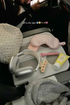 an airplane seat with various items on it, including a travel pillow and other accessories