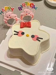 a hello kitty birthday cake with sunglasses on top