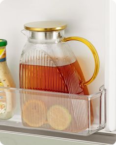 a glass pitcher and some food on a shelf