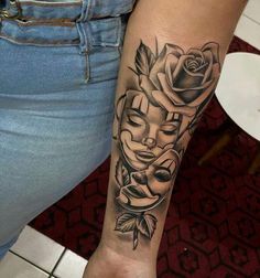 a woman's arm with a tattoo on it and a rose in the center