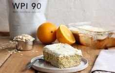 a piece of cake sitting on top of a plate next to an orange and some other food