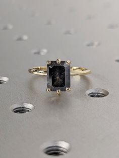 a black diamond ring sitting on top of a table